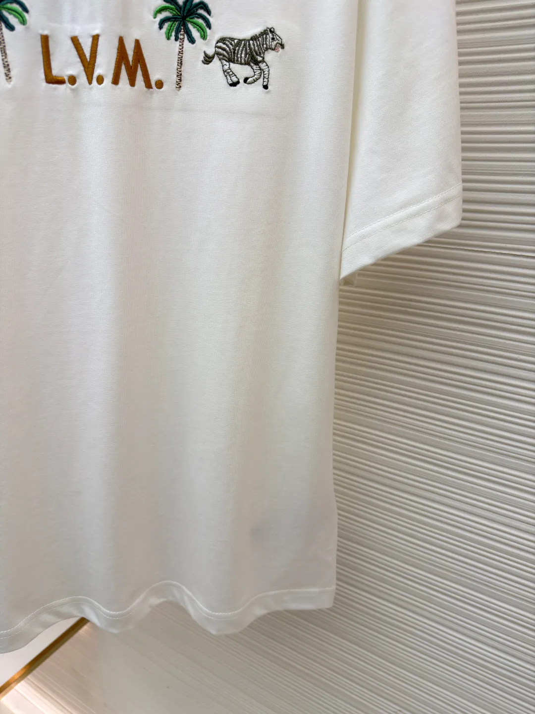 LOUIS VUITTON animal embroidery short-sleeved T-shirt ●Original version: Purchased and developed at 9350 ●Item number: 1682215-A05 ●Fabric: cotton fabric ●Technology: embroidery production ●Color: white ●Version: fitted version ●Weight: about 260 grams ●Size: XS-S-M-L ●Description: This embroidered short-sleeved T-shirt is made of high-end clothing technology. The fabric is made of 260g heavy-weight mercerized cotton. It has been treated with liquid ammonia mercerization to give the cotton a delicate luster. It is also anti-wrinkle and breathable, and its skin-friendliness and drape are greatly improved. The theme pattern on the chest adopts embroidery technology that combines Su embroidery flat stitch and seed embroidery. The animal and plant patterns show three-dimensional texture through different stitching methods. The letters are filled in with embroidery technology. The stitch density reaches 8 stitches per centimeter. The colors are full and the lines are neat. The embroidery edges are overlocked to avoid fuzzing. The neckline is reinforced with three needles and is paired with high-density rib fabric to keep it from loosening after long-term wear. The side seams of the body are seamlessly heat-pressed to reduce friction when worn. The overall style adopts a loose cut with slightly dropped shoulders, combined with three-dimensional cutting technology, which not only ensures wearing comfort, but also modifies the body line. The overall wiring is straight and delicate, the fabric is comfortable and soft, and the color is consistent without color difference. It can be matched with the same style to create a fashionable look and control various occasions. Customized accessories, complete with three standards, same style for men and women!